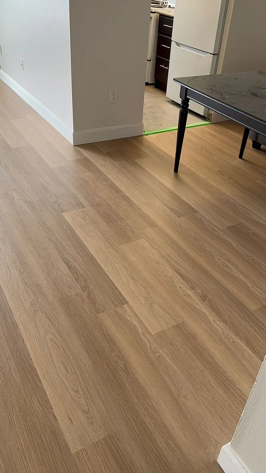 Warm engineered hardwood flooring installed in a commercial space by Geometrix Flooring & Design