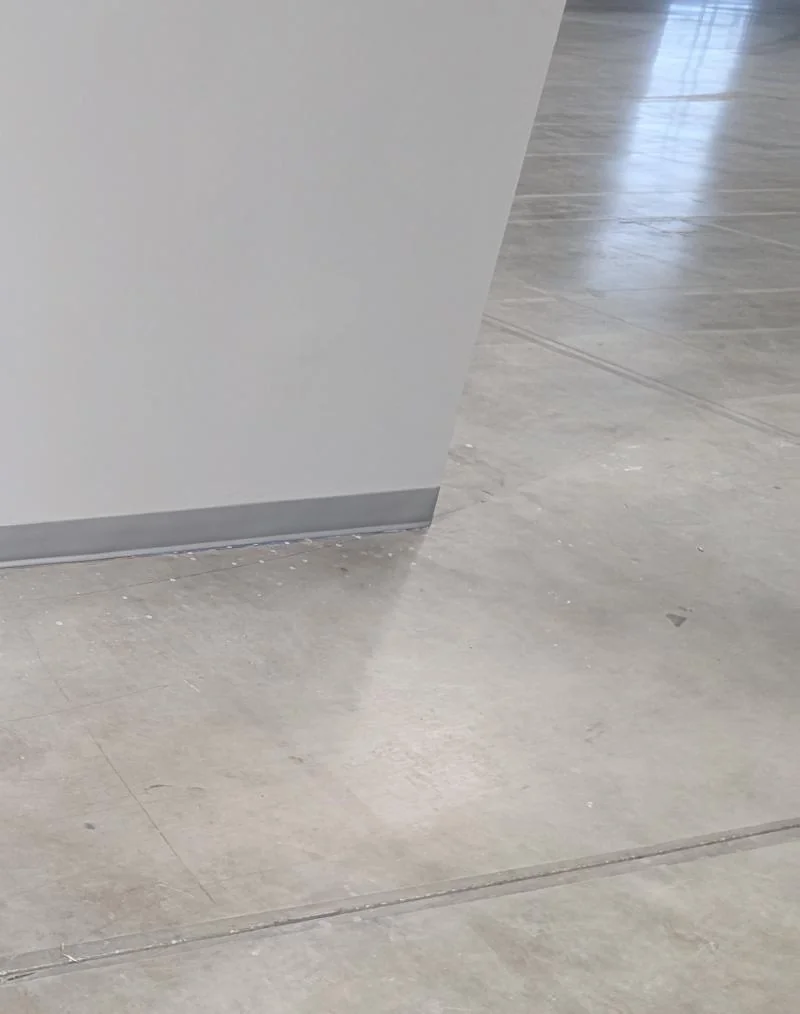 Polished concrete slab with a sealed sheen in a commercial space installed by Geometrix Flooring & Design
