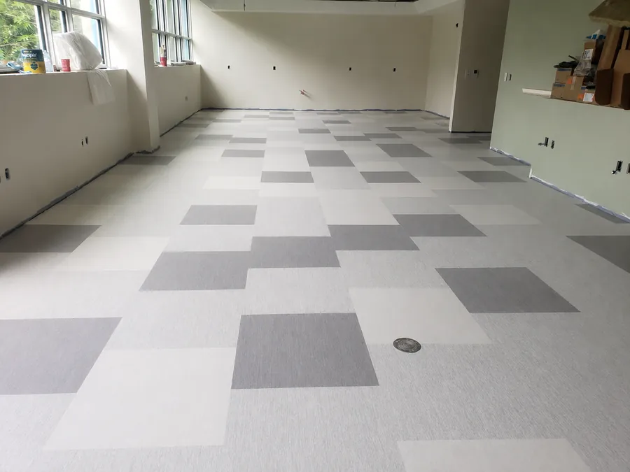 Multi-tone vinyl composition tile (VCT) installed across a commercial institutional floor by Geometrix Flooring & Design