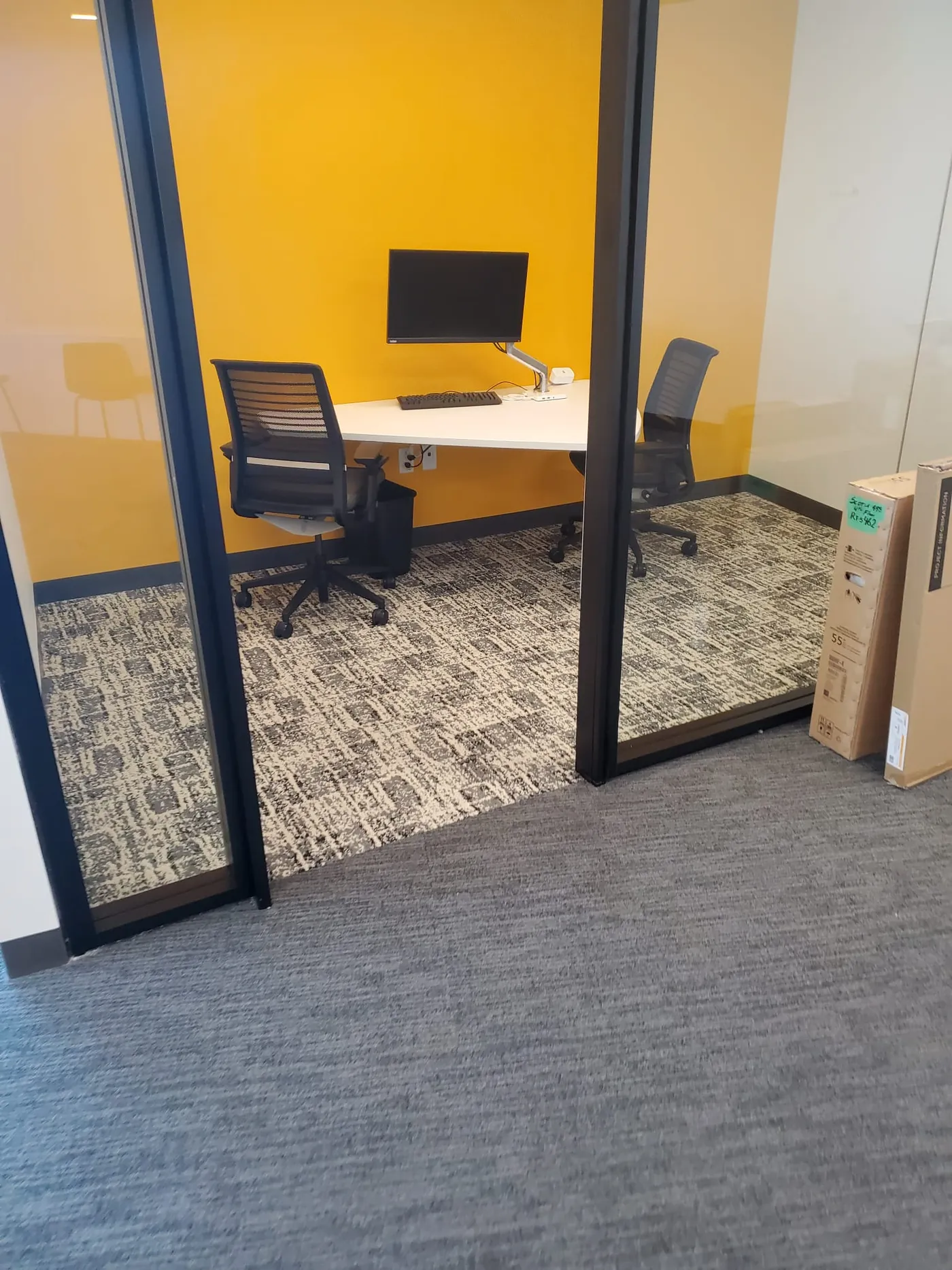 Creative-agency private office with patterned modular carpet tile and yellow accent wall — commercial flooring by Geometrix